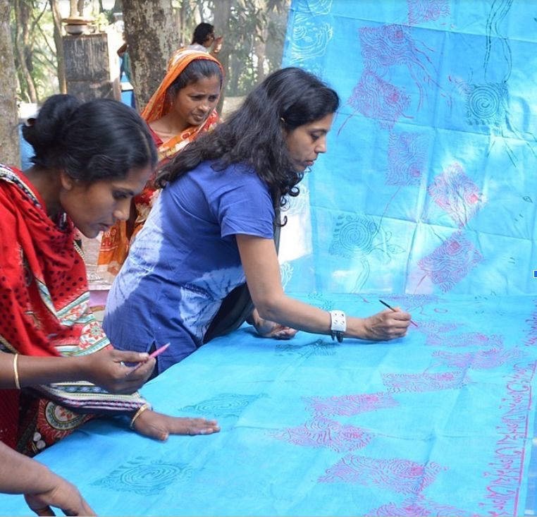Women in Katakhali, Bangladesh making a sari together